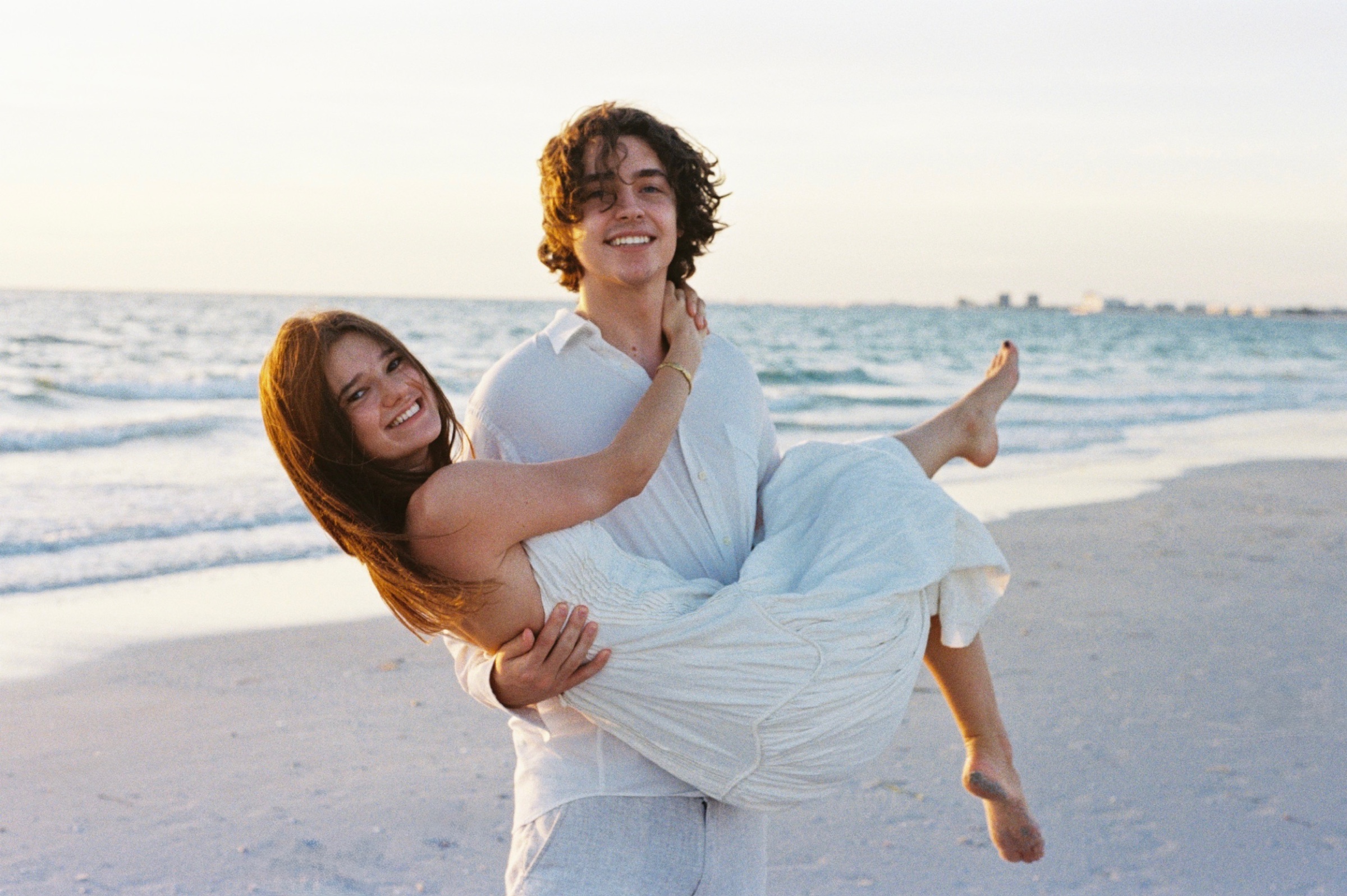Christian holding Grace in his arms on Pass-a-Grille Beach.